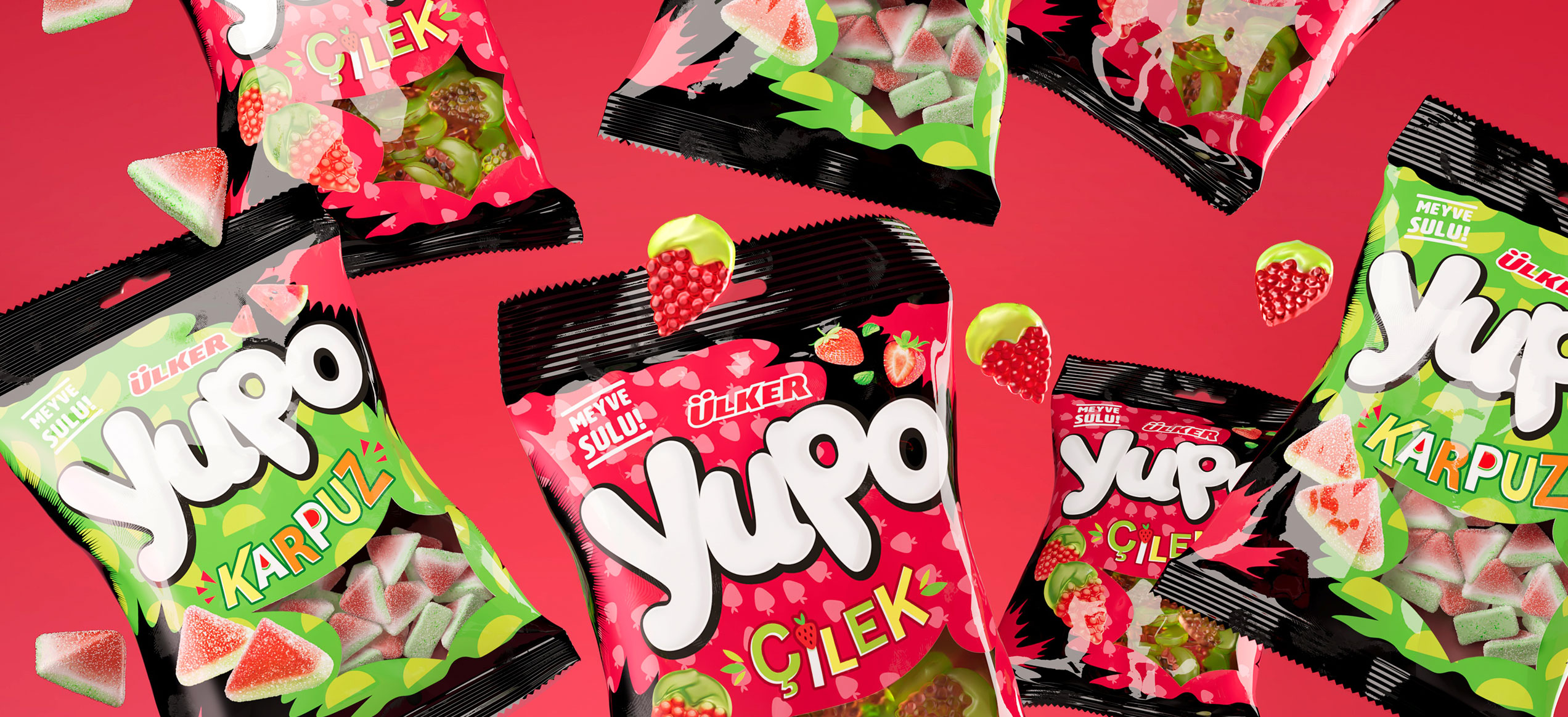 Confezioni di caramelle gommose Ülker Yupo nei gusti fragola e anguria, sospese su fondo rosso con frutti tridimensionali che sembrano fluttuare